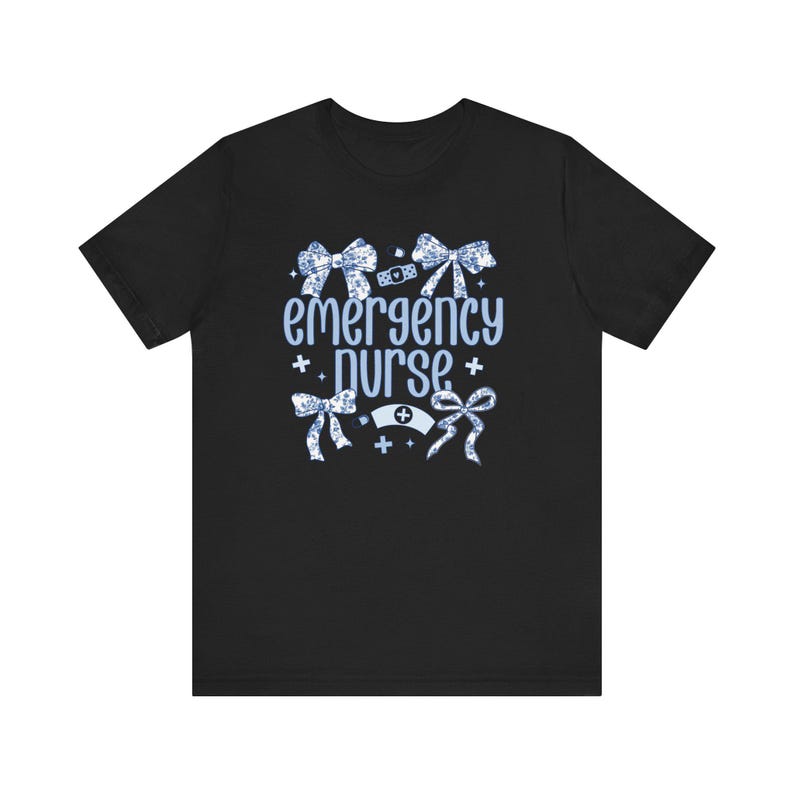May include: Black t-shirt with a blue and white design featuring the text "emergency nurse" and decorative bows.