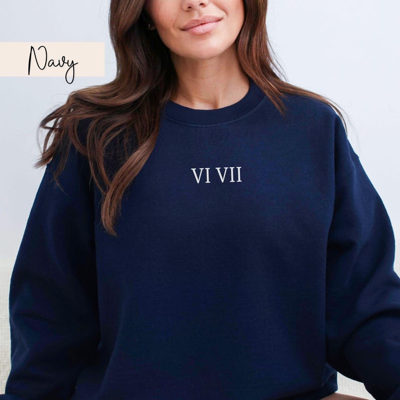 May include: Navy blue sweatshirt with the text "VI VII" in white. The word "Navy" is written in cursive in the upper left corner. The sweatshirt is a solid navy color.