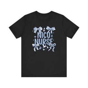 May include: Black t-shirt with a blue and white design featuring bows, baby footprints, a baby bottle, and the text "NICU NURSE".