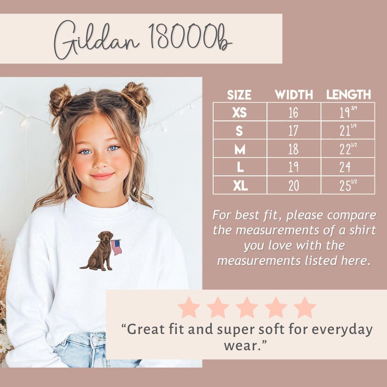 May include: White sweatshirt featuring a brown Labrador Retriever holding an American flag. The sweatshirt has a crew neck and long sleeves. Size chart with measurements in inches is included. The text "Gildan 18000b" is at the top.