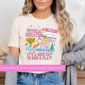 May include: A white t-shirt with a colorful design featuring the words "Welcome to Physical Education" and "It's a good day to run & play!" The design also includes a name tag that says "Hello! Coach Alyssa".
