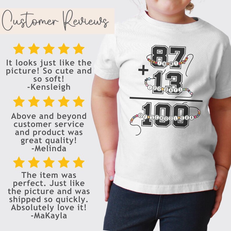 May include: White t-shirt with a black and white graphic of a math equation. The equation reads "87 + 13 = 100". The numbers are surrounded by colorful beads. The text "100 Days of School" is written below the equation.