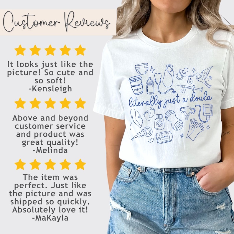 May include: White t-shirt with a blue line drawing of baby-related items and the text "literally just a doula." The shirt also features customer reviews with star ratings.