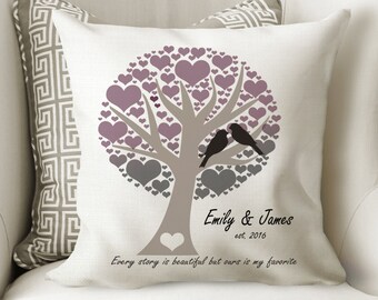 May include: A white throw pillow featuring a grey and purple heart tree design. Two black birds are perched on a branch. The text "Emily & James est. 2016" and "Every story is beautiful but ours is my favorite" is printed below the tree.