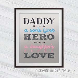 May include: A framed print with the text "Daddy, a son's first hero, a daughter's first love" in black with blue and pink accents on a gray background. The text "Customize Your Colors" is at the bottom of the print.