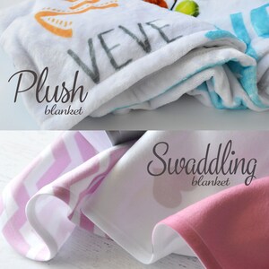 May include: Two baby blankets, one plush and one swaddling. The plush blanket is white with a blue border and the swaddling blanket is pink with a white chevron pattern.