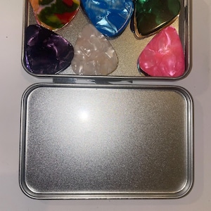 set of 24 plectrums in a tin