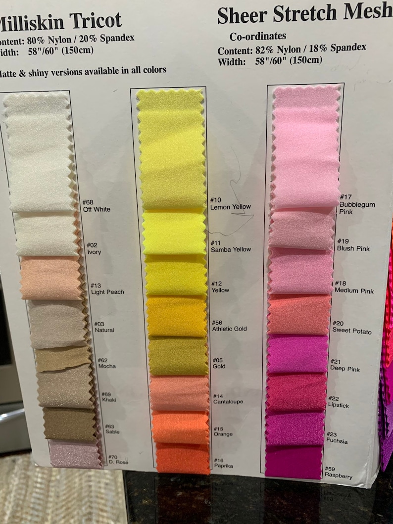 May include: Swatch card displaying a range of sheer stretch mesh fabric colours. The fabric comes in widths of 58" or 60". The colours include off white, ivory, light peach, natural, mocha, khaki, sable, dark rose, lemon yellow, samba yellow, yellow, athletic gold, gold, cantaloupe, orange, paprika, bubblegum pink, blush pink, medium pink, sweet potato, deep pink, lipstick, fuchsia, and raspberry.