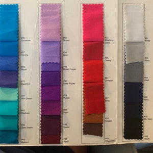 May include: Fabric swatches in a range of colours, including turquoise, orchid, shocking coral, white, silver, steel, brick, navy, copper, chocolate and black. Each swatch is labelled with a number.