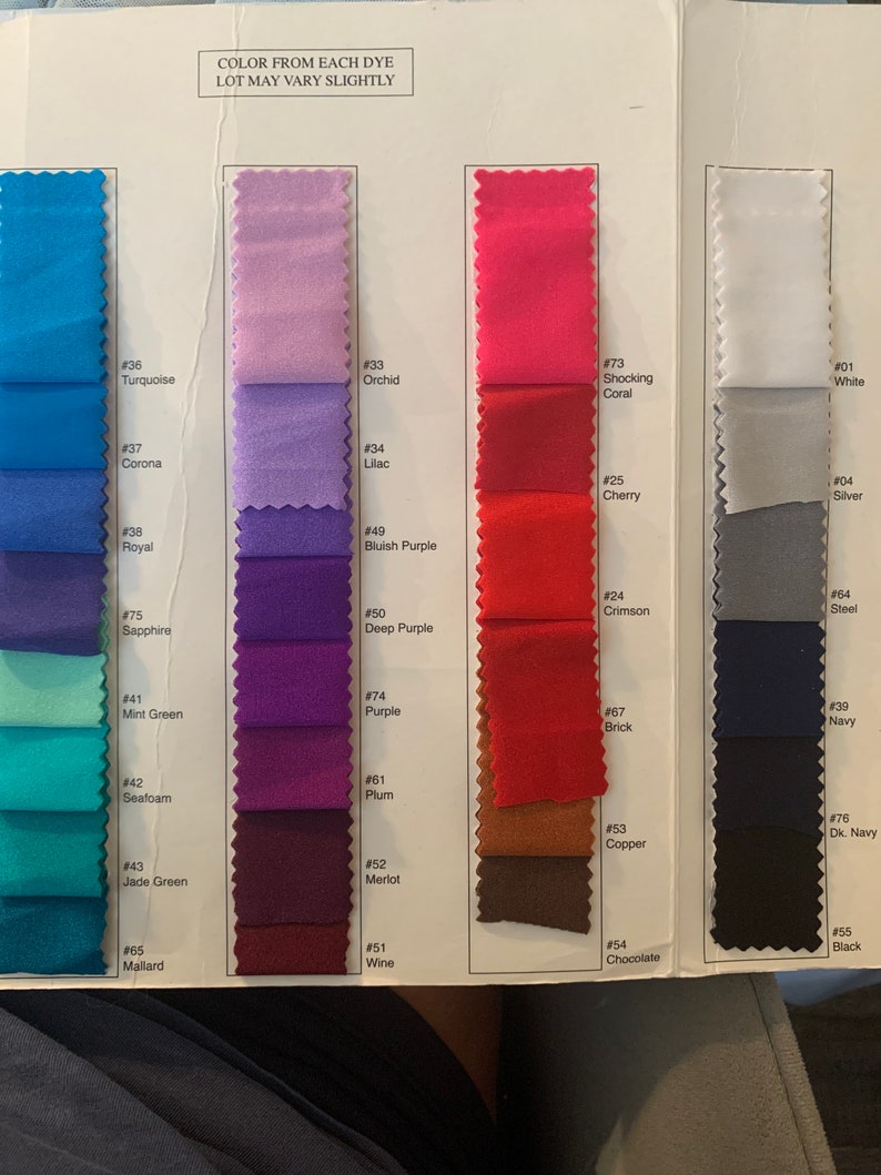 May include: Fabric swatches in a range of colours, including turquoise, orchid, shocking coral, white, silver, steel, brick, navy, copper, chocolate and black. Each swatch is labelled with a number.