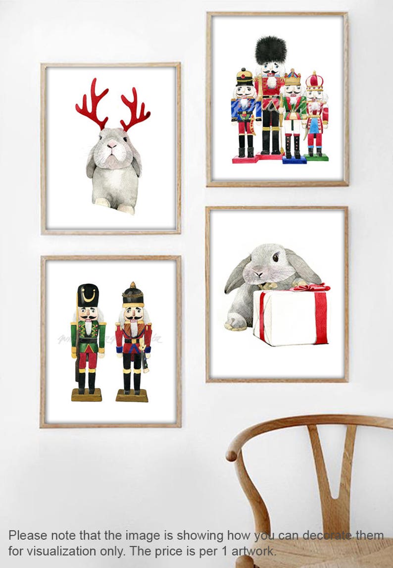 May include: Set of four watercolor prints featuring a gray rabbit wearing reindeer antlers, a gray rabbit holding a gift box, and two nutcracker soldiers. The prints are framed in a light wood frame.