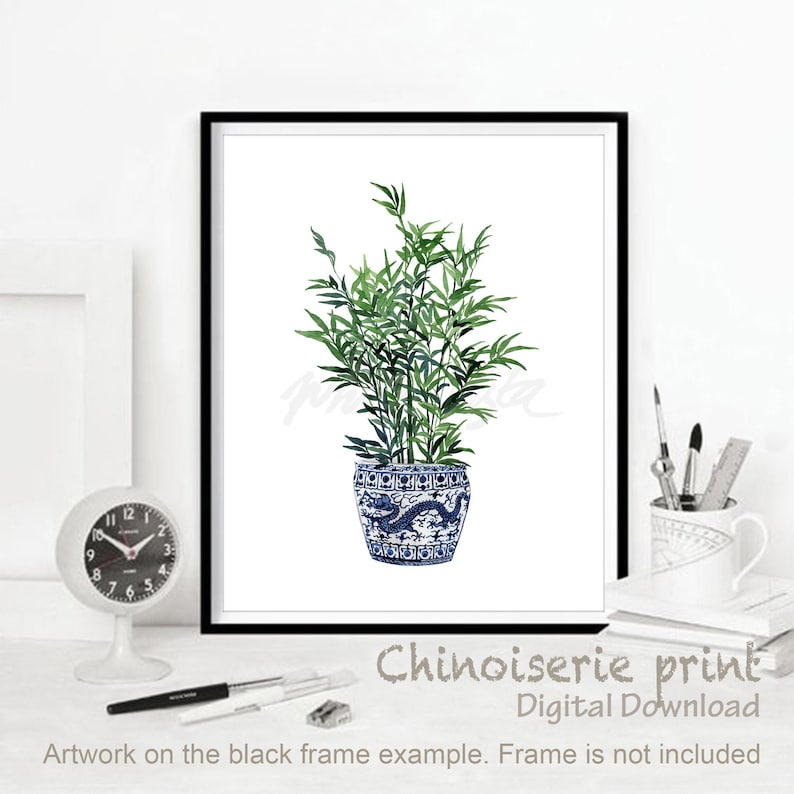 May include: A digital print of a blue and white chinoiserie planter with a green leafy plant inside. The text "Chinoiserie print" and "Digital Download" is below the image. The text "Artwork on the black frame example. Frame is not included" is below the text.