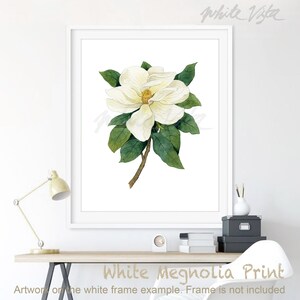 May include: A watercolor painting of a white magnolia flower with green leaves. The flower has a yellow center and is in bloom. The painting is on a white background.