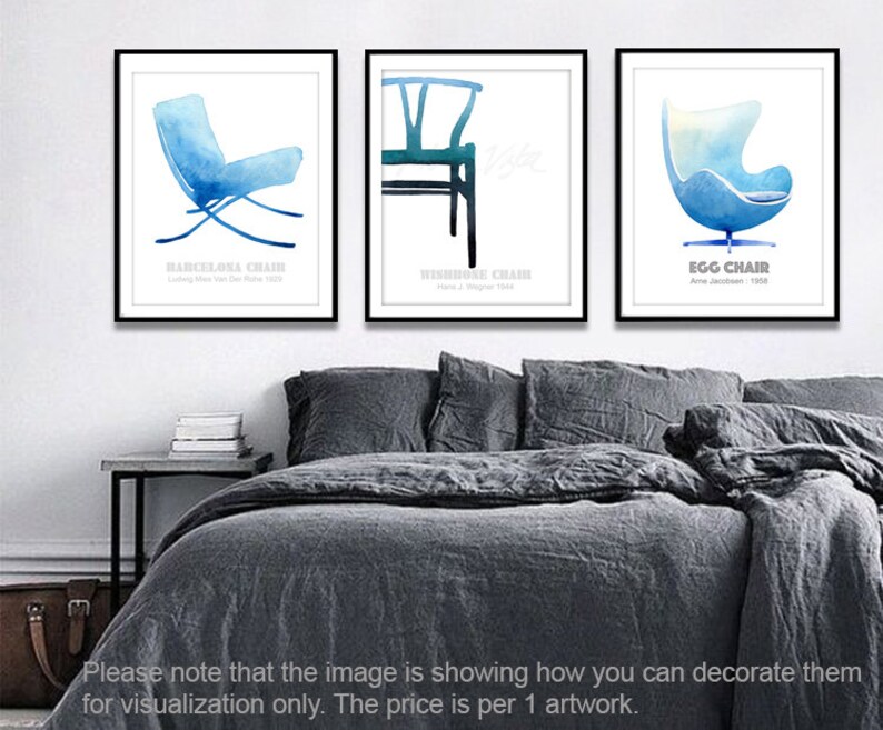 May include: Three watercolor illustrations of iconic chairs: the Barcelona Chair, the Wishbone Chair, and the Egg Chair. Each illustration is framed and displayed on a white wall above a gray bed.