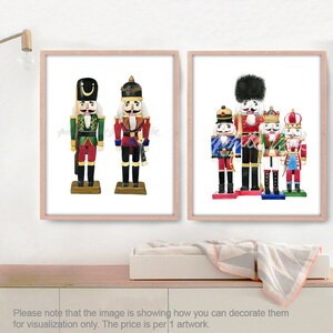 May include: Two framed watercolor paintings of nutcracker soldiers. The first painting features two nutcracker soldiers, one in green and red and the other in red and gold. The second painting features five nutcracker soldiers in various colors and poses.