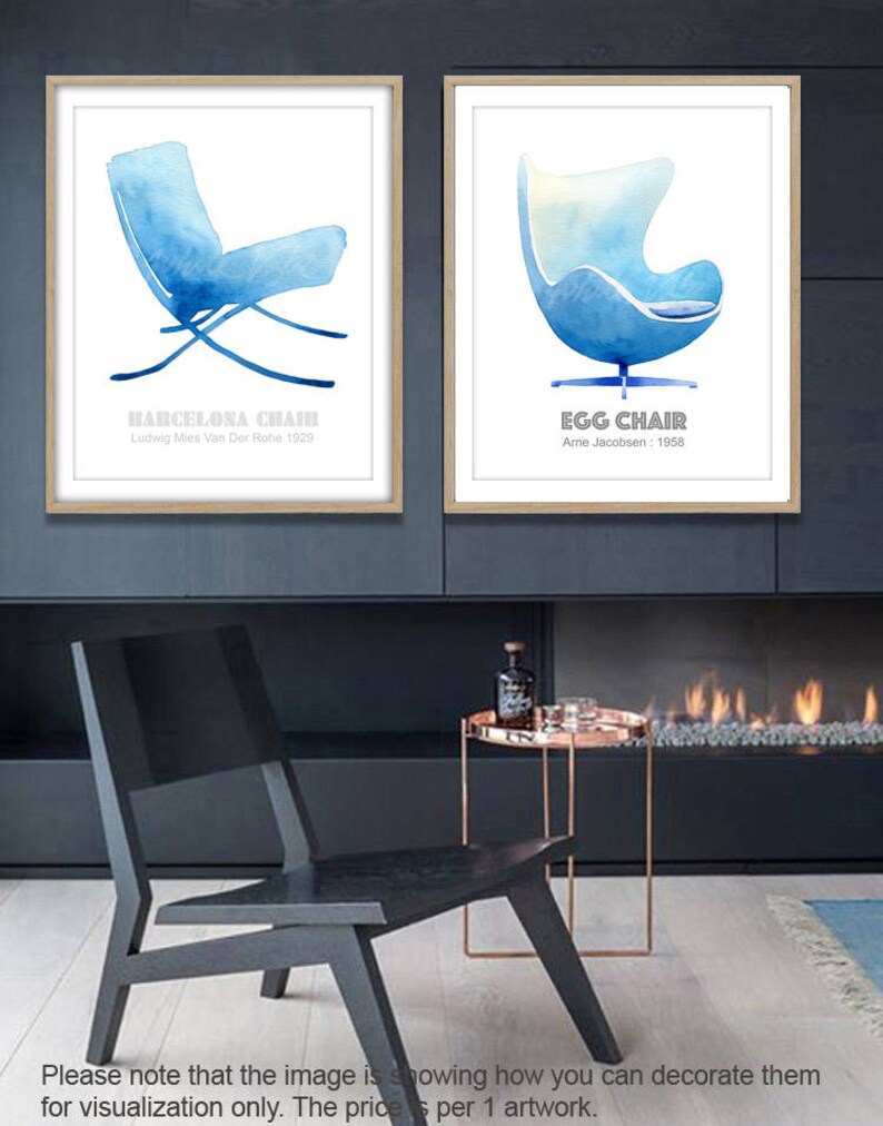 May include: Two watercolor prints of iconic chairs, the Barcelona Chair by Ludwig Mies Van Der Rohe and the Egg Chair by Arne Jacobsen. The prints are framed in wood and displayed on a wall above a fireplace.