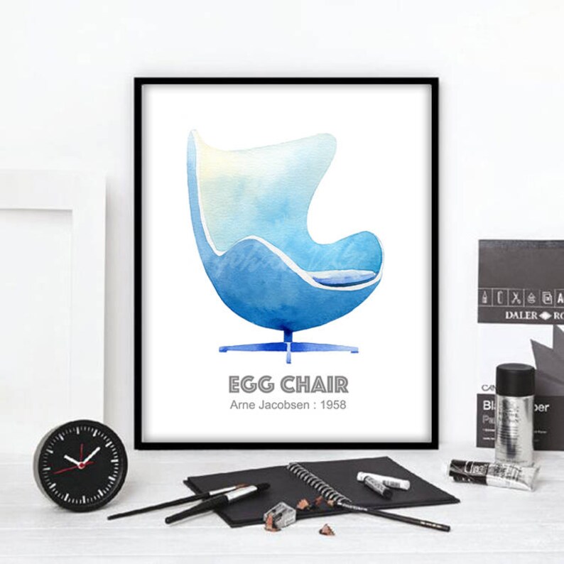 May include: A watercolor illustration of a blue Egg Chair designed by Arne Jacobsen in 1958. The chair is depicted against a white background with the text "Egg Chair" and "Arne Jacobsen: 1958" below it.