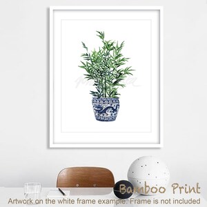 May include: A watercolor painting of a green bamboo plant in a blue and white porcelain pot with a dragon design. The plant is in a white frame.