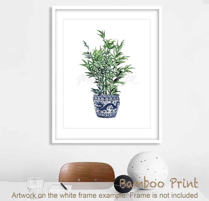 May include: A watercolor painting of a green bamboo plant in a blue and white porcelain pot with a dragon design. The plant is in a white frame.