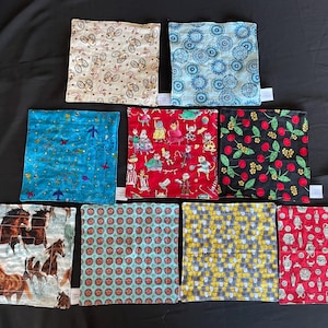 May include: Ten different fabric squares with various patterns. The patterns include horses, cherries, bicycles, cats, and geometric designs. The squares are all approximately the same size and are arranged in two rows of five.