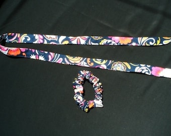 May include: A long, thin, blue and white patterned fabric ribbon with a matching fabric scrunchie.