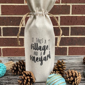 This ‘It Takes a Village and a Vineyard’ canvas wine bottle bag is excellent for jazzing up a gift or adding personality to that wine bottle sitting on your counter. This design is printed on a 100% linen pouch with a jute drawstring.