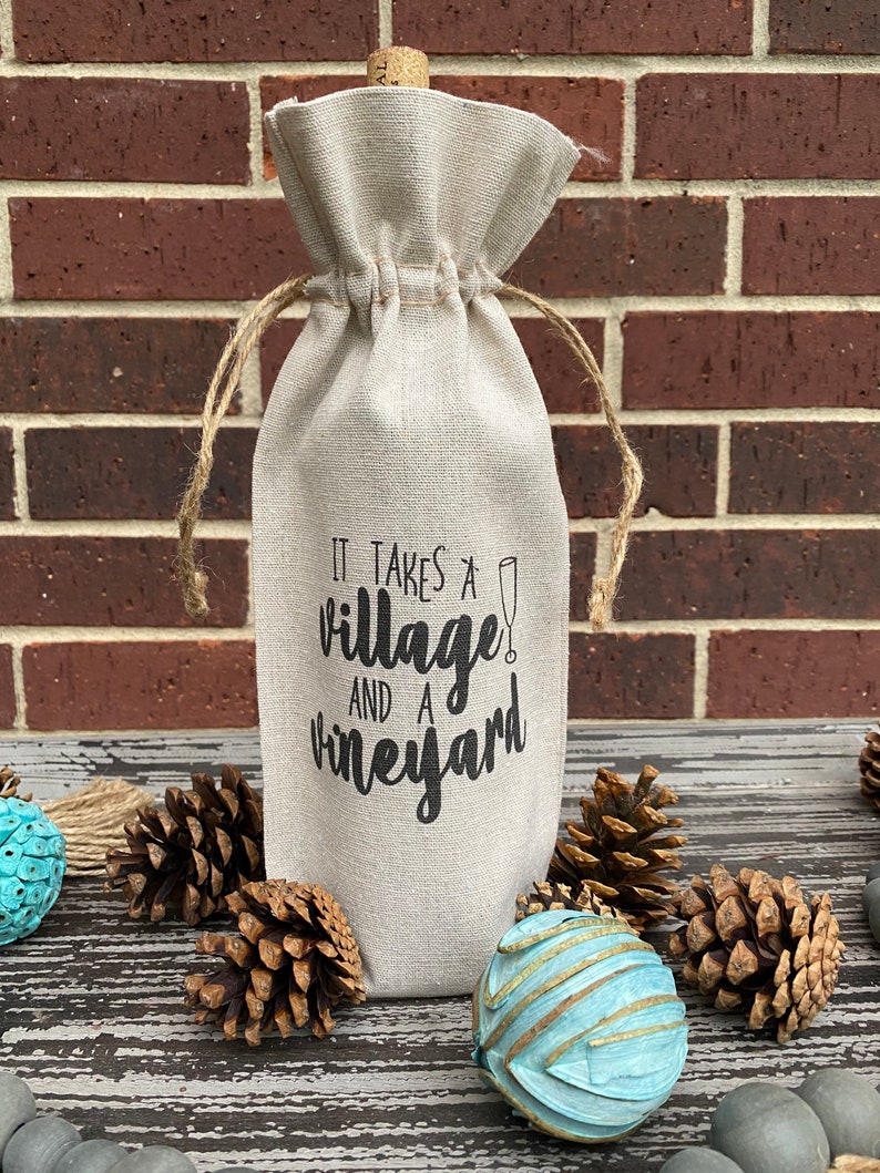 This ‘It Takes a Village and a Vineyard’ canvas wine bottle bag is excellent for jazzing up a gift or adding personality to that wine bottle sitting on your counter. This design is printed on a 100% linen pouch with a jute drawstring.