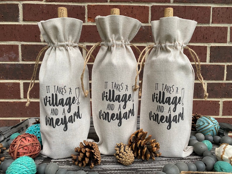 This ‘It Takes a Village and a Vineyard’ canvas wine bottle bag is excellent for jazzing up a gift or adding personality to that wine bottle sitting on your counter. This design is printed on a 100% linen pouch with a jute drawstring.