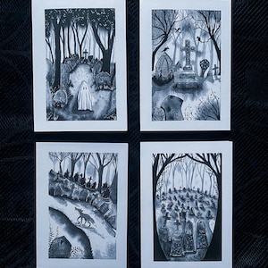 May include: Set of four grayscale art prints featuring spooky cemetery scenes. Each print depicts a different view of a graveyard with trees, tombstones, and a ghost or animal. The artwork is in a watercolor style, with a focus on shadows and details.