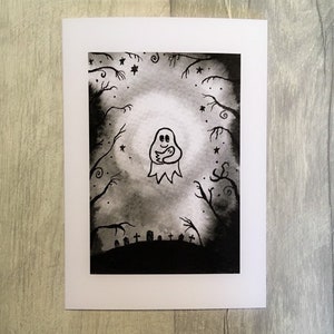 May include: A Halloween-themed greeting card featuring a watercolor illustration. The artwork depicts a friendly ghost with a smaller ghost inside, surrounded by a spooky forest, stars, and a graveyard. The color palette is primarily black and white.