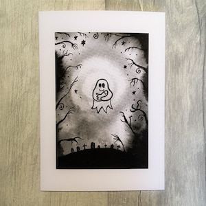 May include: A Halloween-themed greeting card featuring a watercolor illustration. The artwork depicts a friendly ghost holding a smaller ghost, surrounded by a spooky forest, stars, and a graveyard. The color palette is primarily black, white, and gray.