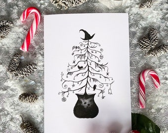 May include: A white card featuring a black illustration of a Halloween-themed Christmas tree. The tree is adorned with bats, spiders, and a witch's hat. The tree sits atop a cauldron. Candy canes and pinecones surround the card.