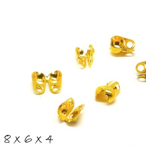 May include: Eight gold-toned metal crimp beads for jewellery making. The beads are designed to be crimped onto a cord or string to secure a knot or loop.