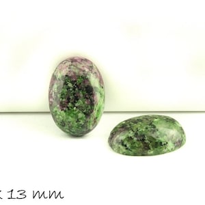 Könnte beinhalten: Zwei ovale, grüne und rosafarbene Edelsteinkabochons mit den Maßen 18 x 13 mm. Die Cabochons haben ein geflecktes Muster in Grün, Rosa und Schwarz.