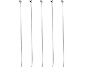 May include: Five silver head pins, each with a small round head, are arranged in a row. The pins are 50 mm long.