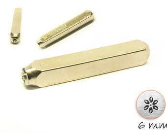 May include: A metal stamp with a 6 mm flower design. The stamp is used for creating impressions in metal. The stamp is made of metal and has a silver finish.