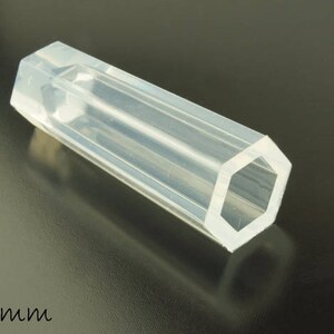 May include: A clear, hexagonal silicone mould for making candles or soap. The mould is 4.5 inches long.