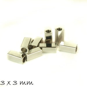 May include: A group of silver metal spacer beads, each measuring 7mm x 3mm x 3mm. The beads are rectangular in shape with a hole in the center.