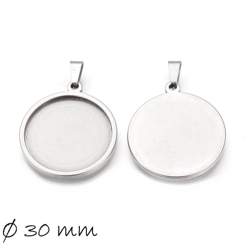May include: A silver pendant with a 30 mm round bezel, shown from both the front and back. The pendant is designed to hold a flat, round piece of glass or other material.