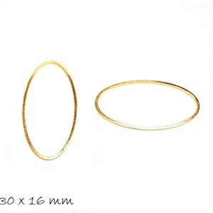 Könnte beinhalten: Zwei goldfarbene ovale Schmuckanhänger aus Metall. Die Anhänger sind etwa 3 cm lang und 1,6 cm breit. Der Text "30 x 16 mm" befindet sich am unteren Rand des Bildes.