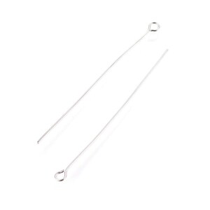 May include: Two silver head pins with a loop at the top. The pins are straight and slender.