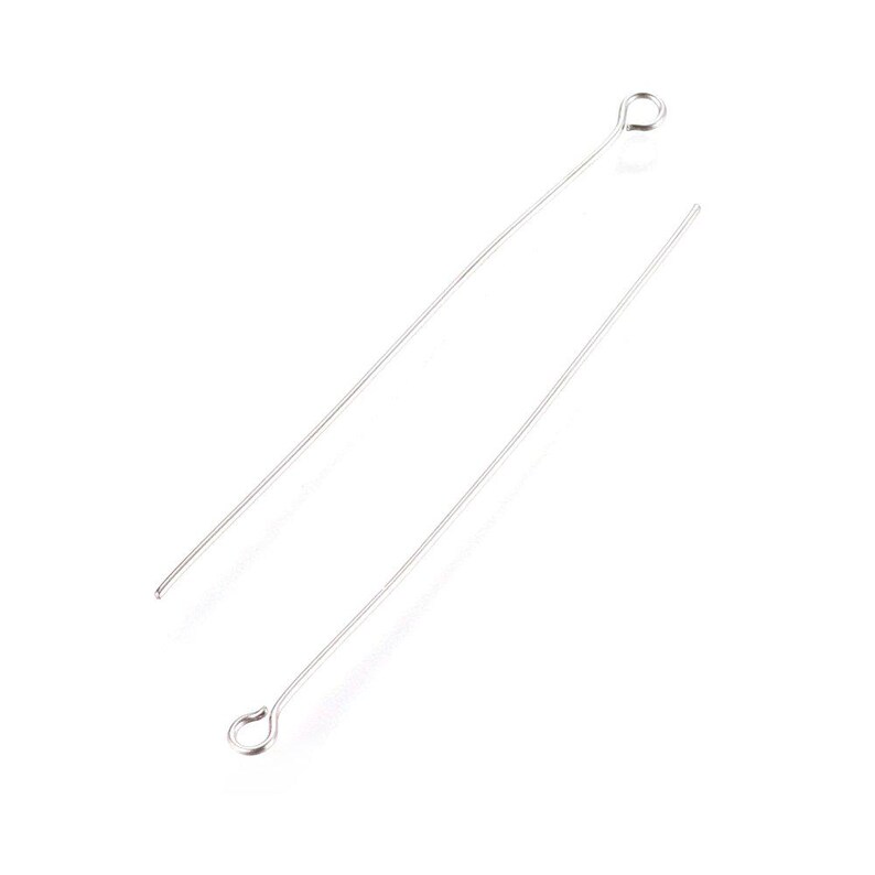 May include: Two silver head pins with a loop at the top. The pins are straight and slender.
