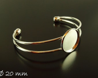 May include: Silver bangle bracelet with a 20 mm round glass cabochon.