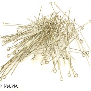 May include: A pile of silver-toned head pins with loops on one end. The pins are 50 mm long.