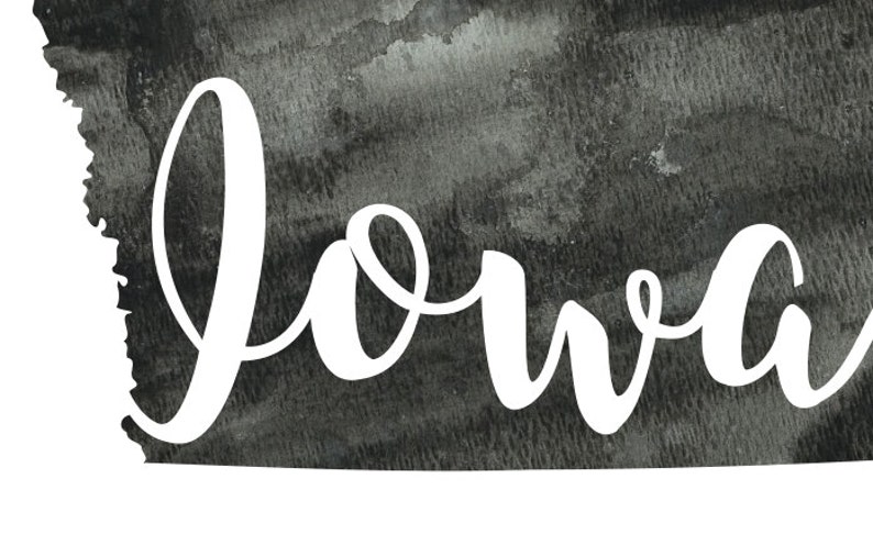 May include: A black and white watercolor illustration of the state of Iowa with the word "Iowa" written in white cursive lettering.