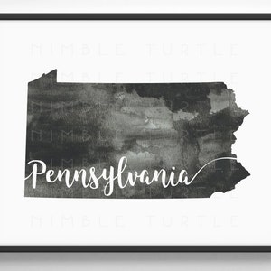 May include: A black and white watercolor illustration of the state of Pennsylvania. The state outline is filled with a dark gray watercolor wash and the word "Pennsylvania" is written in white cursive lettering.