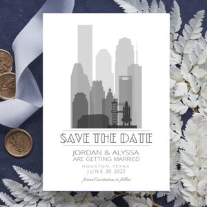 May include: A save the date card with a gray silhouette of the Houston skyline, including the Space Center Houston. The text reads "Save the Date, Jordan & Alyssa are getting married, Houston, Texas, June 30, 2022, formal invitation to follow."