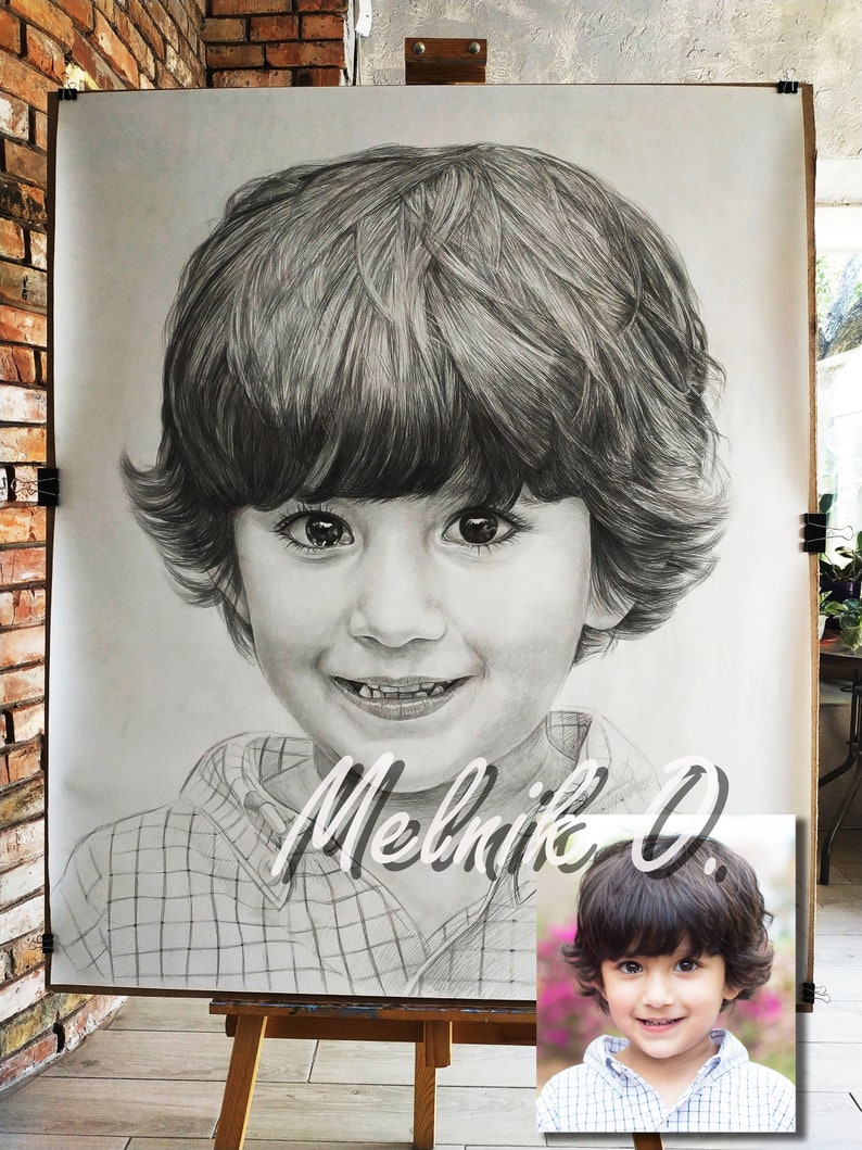 May include: A black and white pencil drawing of a young boy with short brown hair. The drawing is on a large sheet of paper and is framed by a wooden easel. The boy is wearing a plaid shirt and has a friendly smile. The artist's signature, "Melnik O.", is written in cursive below the drawing.