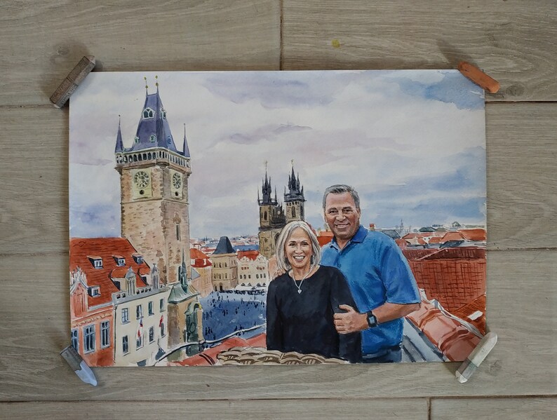 May include: A watercolor painting of a couple standing in front of a cityscape. The couple is dressed in casual clothing and is smiling. The cityscape is a mix of old and new buildings, with a large clock tower in the background.