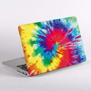 May include: A laptop computer featuring a vibrant tie-dye pattern on its lid. The design displays a swirling explosion of bright colors including yellow, red, blue, green, and purple, radiating from a central point across the entire surface.
